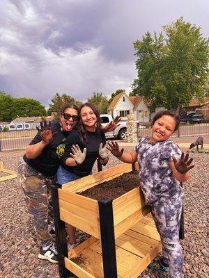 Staff and youth with a new raised garden bed